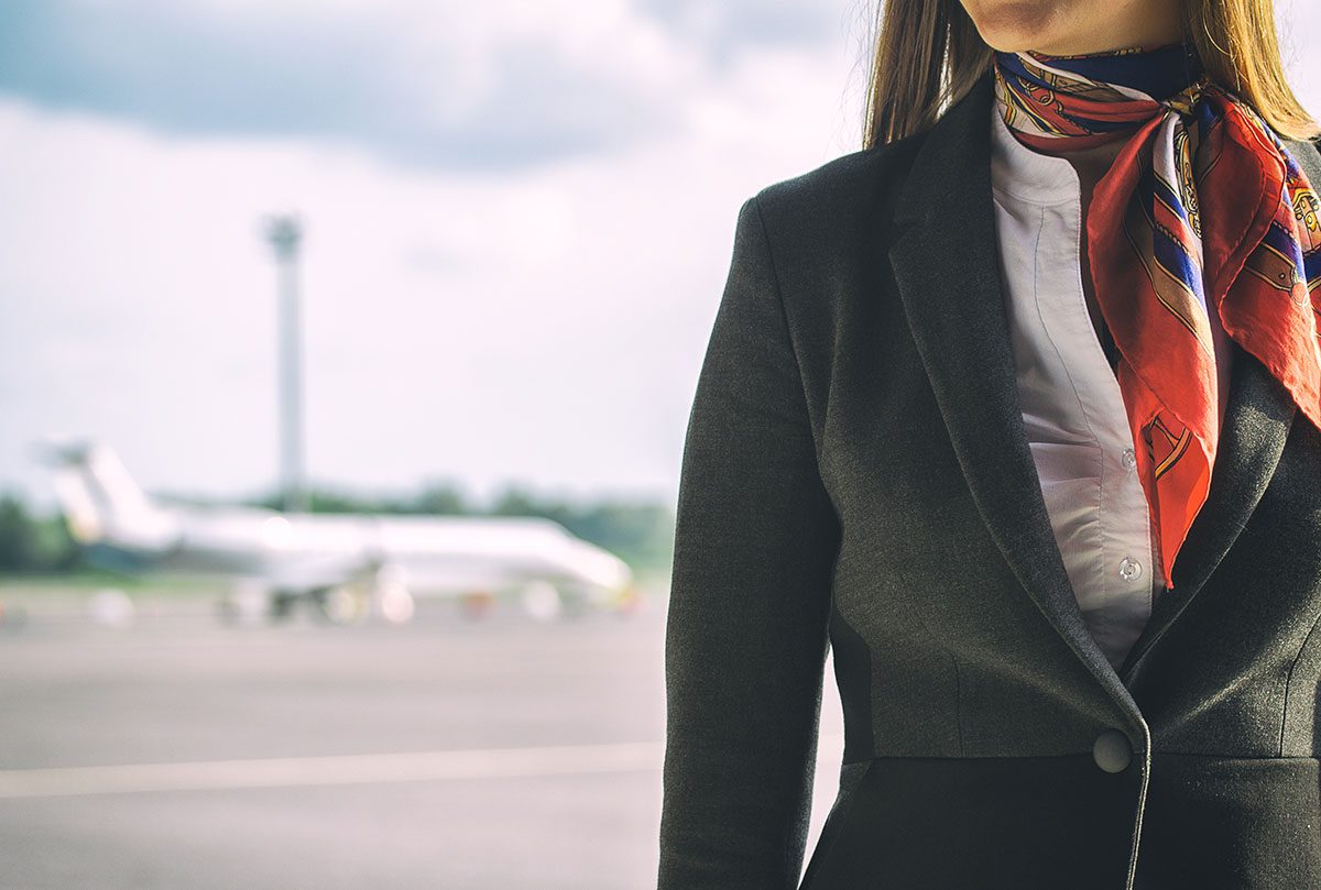 Close up on airline stewardess on tarmac