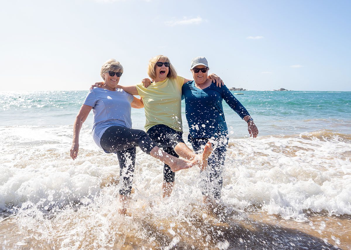 Older women playing in the surf