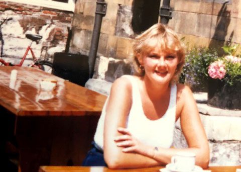 Older photo of woman sitting at table