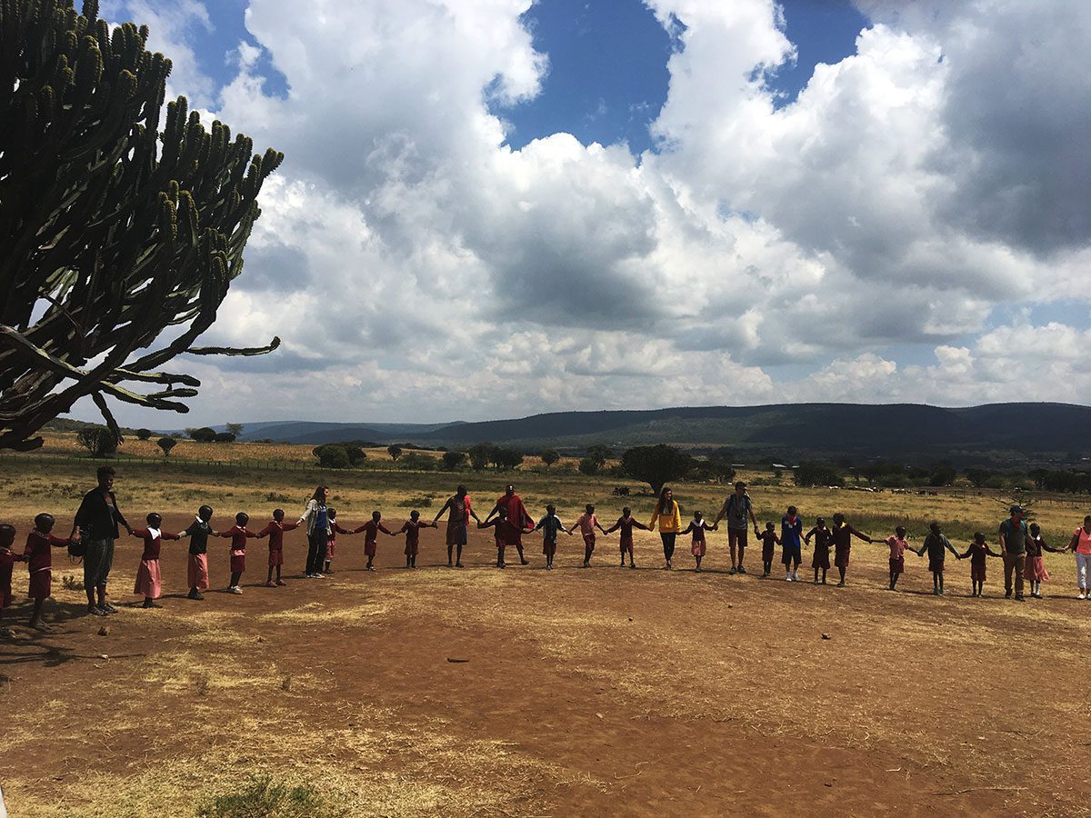 The group stands in a circle holding hands