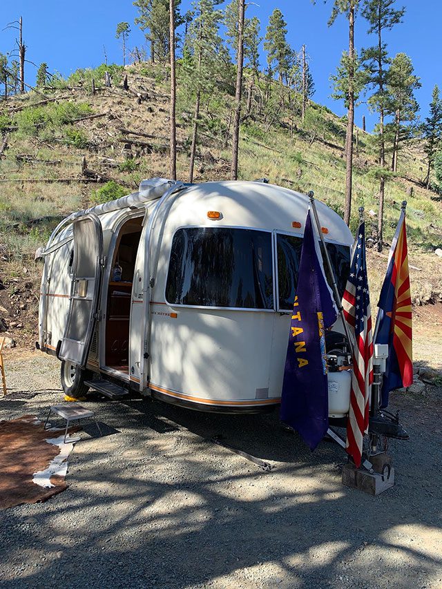 A 1976 Argosy camper with three flags attached to the back