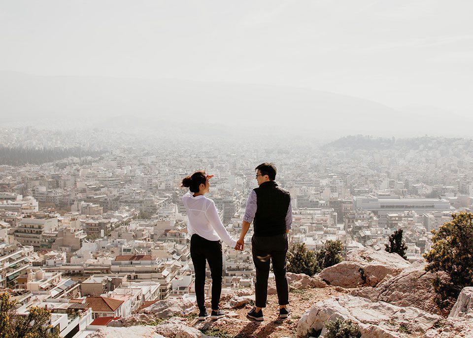 Man and woman holding hands overlooking valley