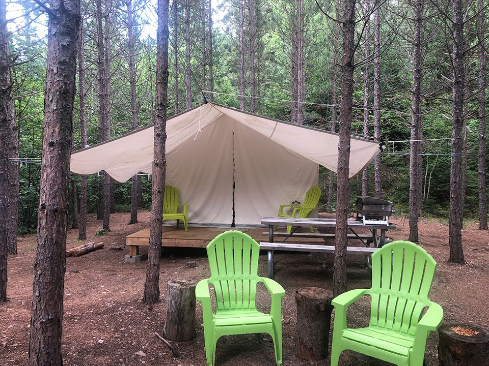 Glamping vs camping campground with covered seating