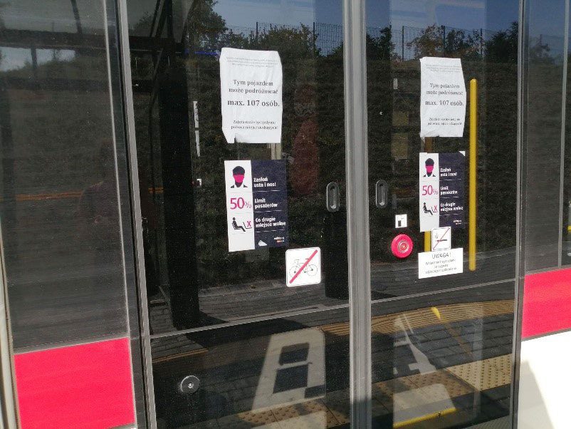 Signs on a bus in Poland saying how to stay safe during COVID