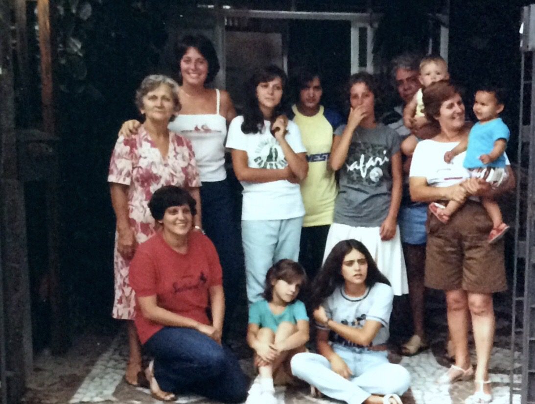 Sue (back, left) with her adopted Brazilian family in the summer of 1977 A group of smiling people in Brazil