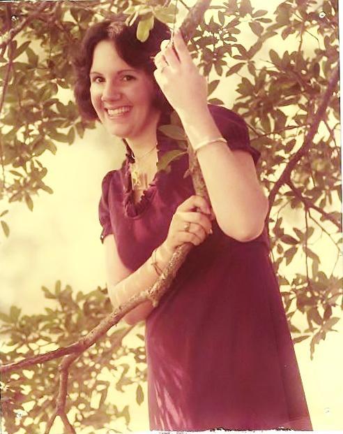 Angela Dowdy standing amongst tree branches