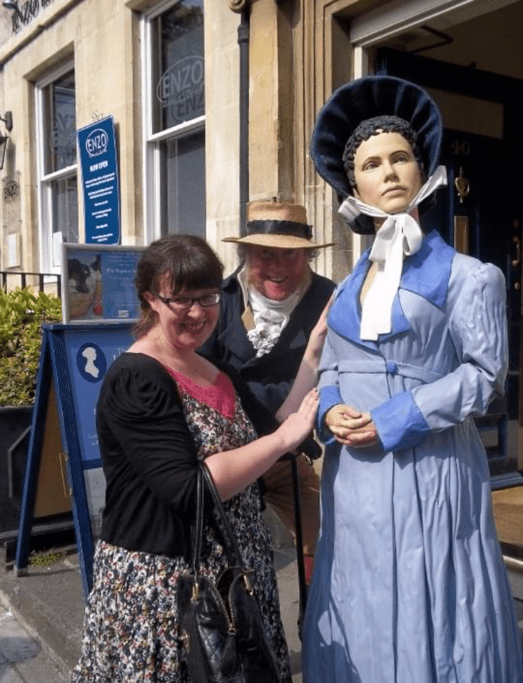Erin Jones posing with a mannequin in an old fashioned outfit.