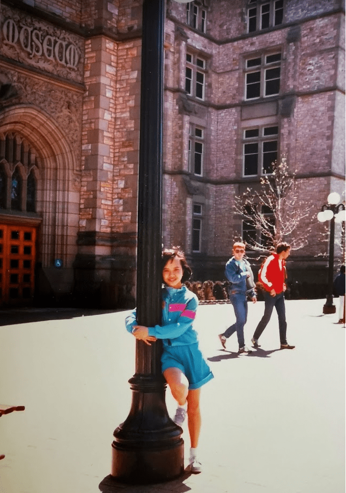 A young Stephanie hugging a light pole