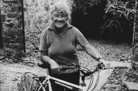 Black and white photo of Dervla Murphy with a bicycle