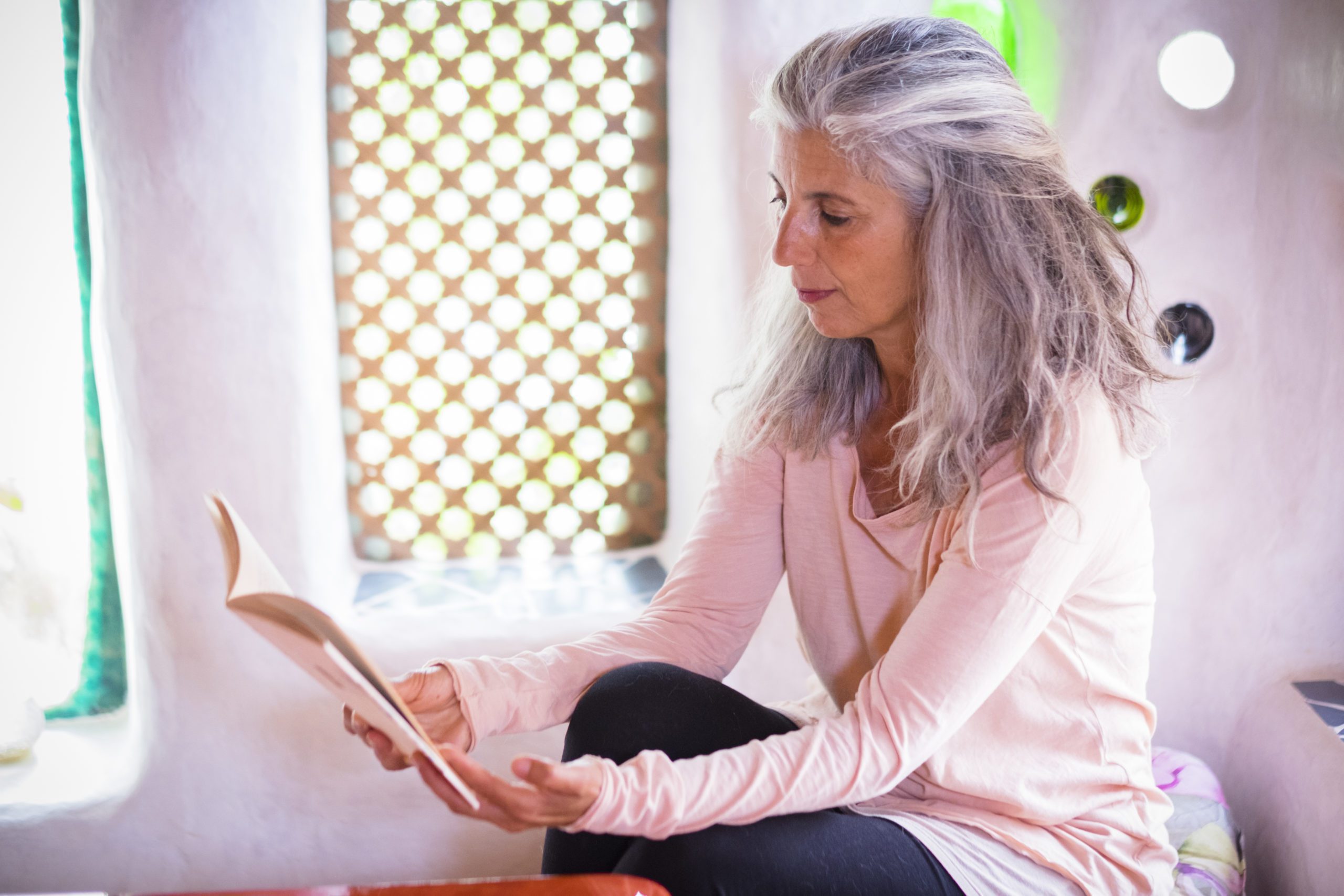 senior woman read a paper book at home