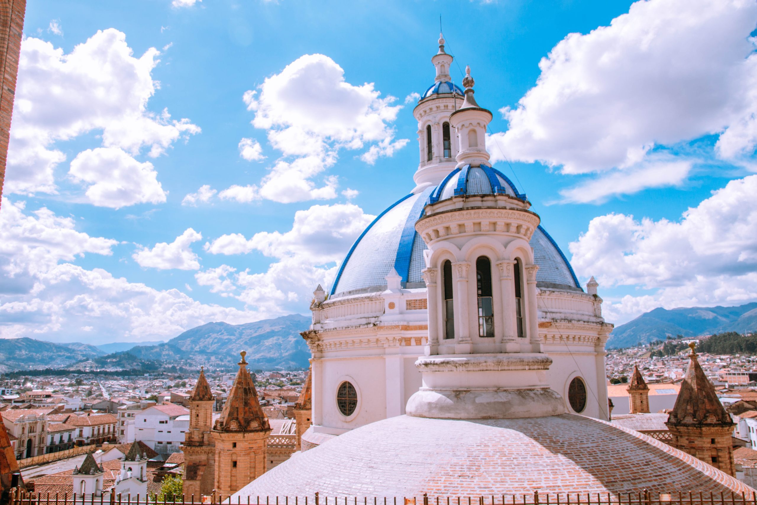 Domed blue building with clouds in the sky