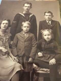 Joy with her mother and brothers in their donated clothing from Sally Ann