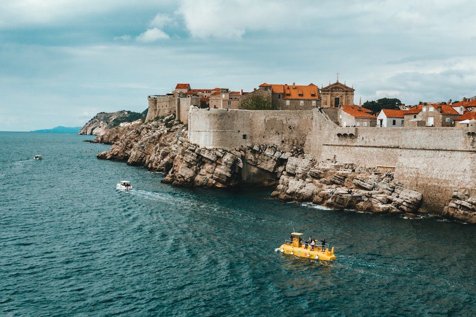 Two boats sailing past the old town in Split Croatia