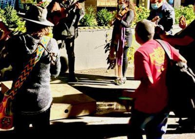 A group of street musicians and dancers
