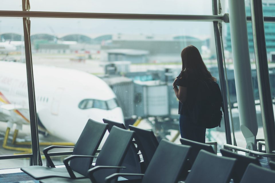 A woman traveler with backpack at the airport