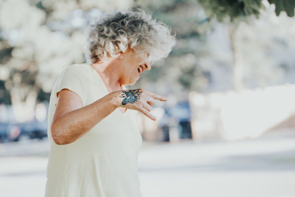 An older woman with a butterfly tattoo