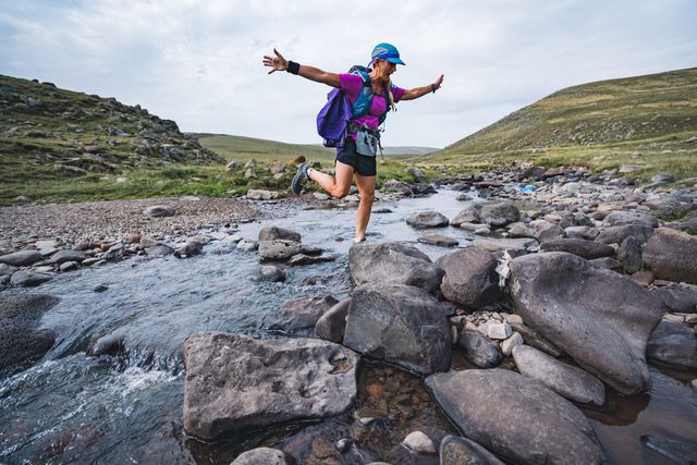 Leaping river rocks with joy on a big run in the country of Georgia age exercise travel