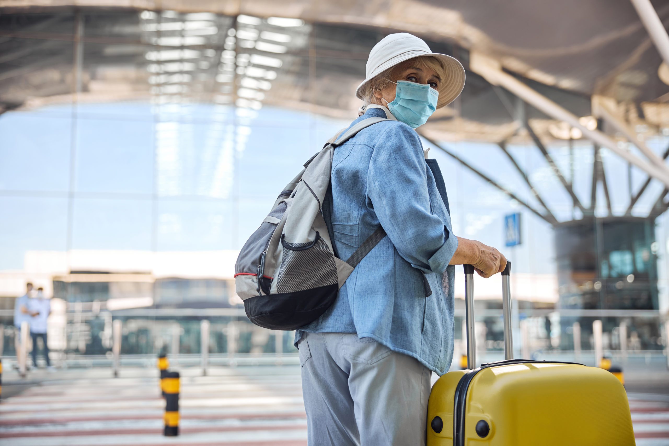 edlerly lady at airport with mask