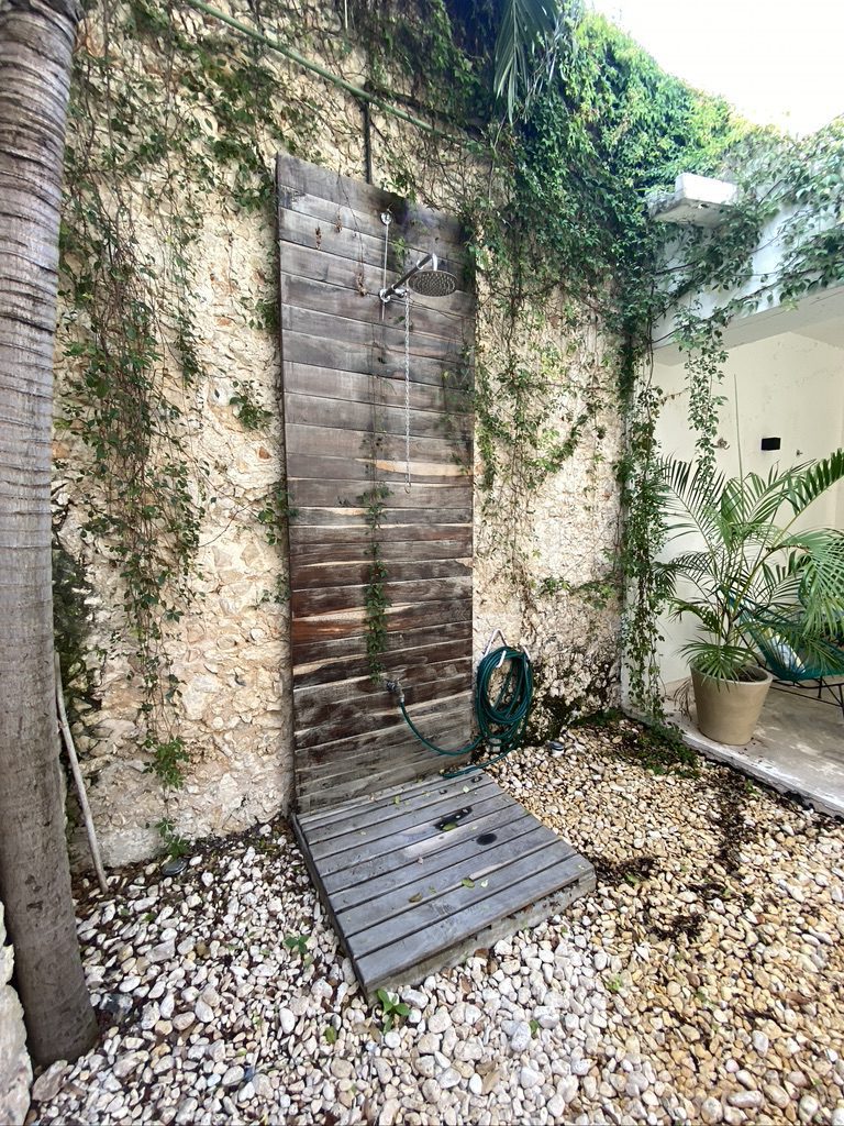 A hammock hanging on the patio of a Tulum villa