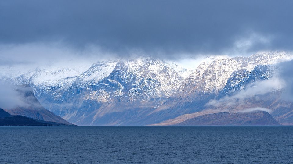 Dramatic Mountains Breaking Through the Coastal Clouds in Auyuittiq National Park on Baffin Island near Pangnirtung, Nunavut, Canada