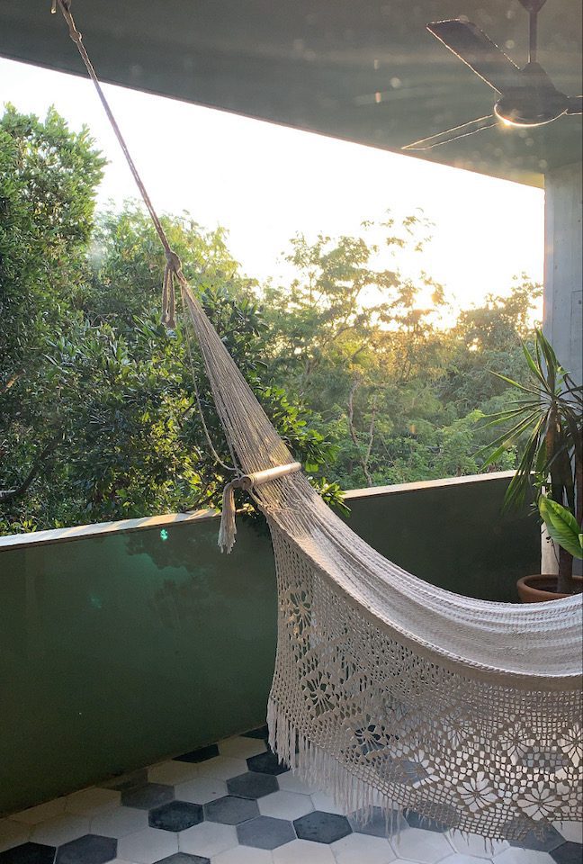 A hammock hanging on the patio of a Tulum villa