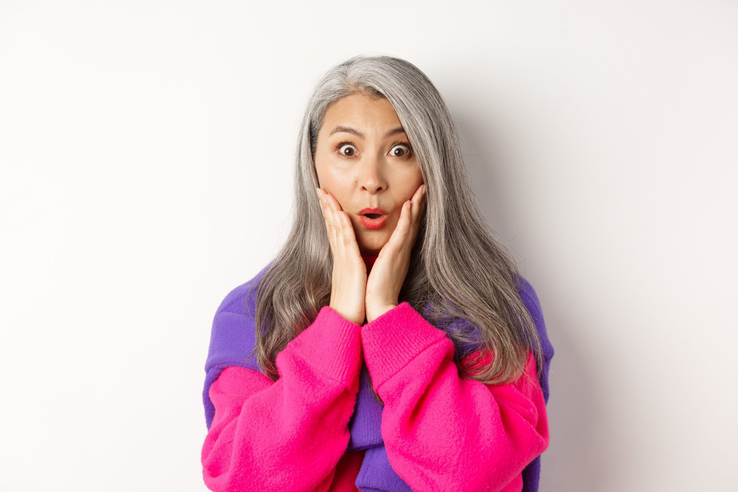 woman in pink looking surprised