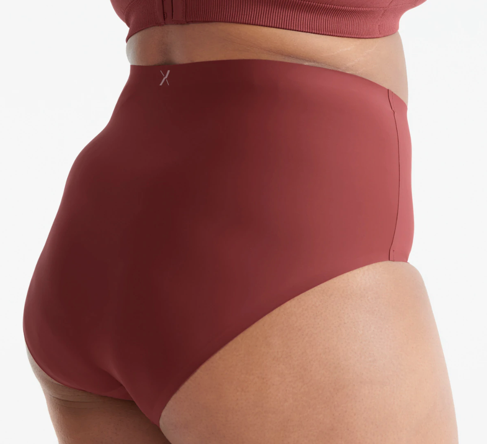 A woman wearing a black pyjama set from Knix