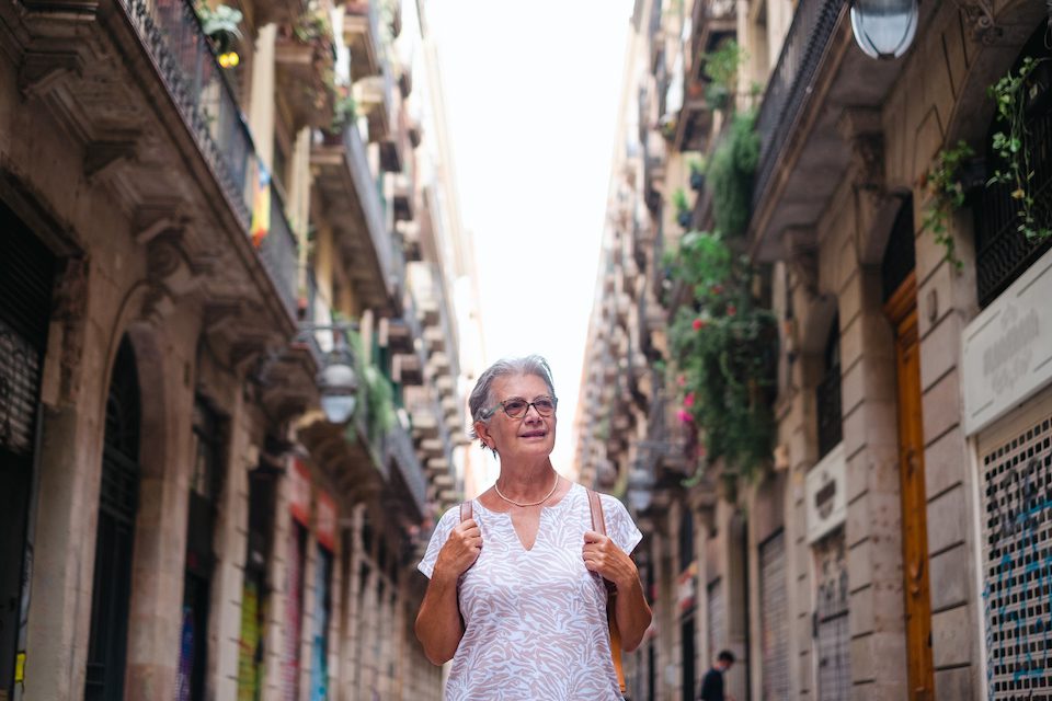 Elderly woman travels to Barcelona solo travel at home