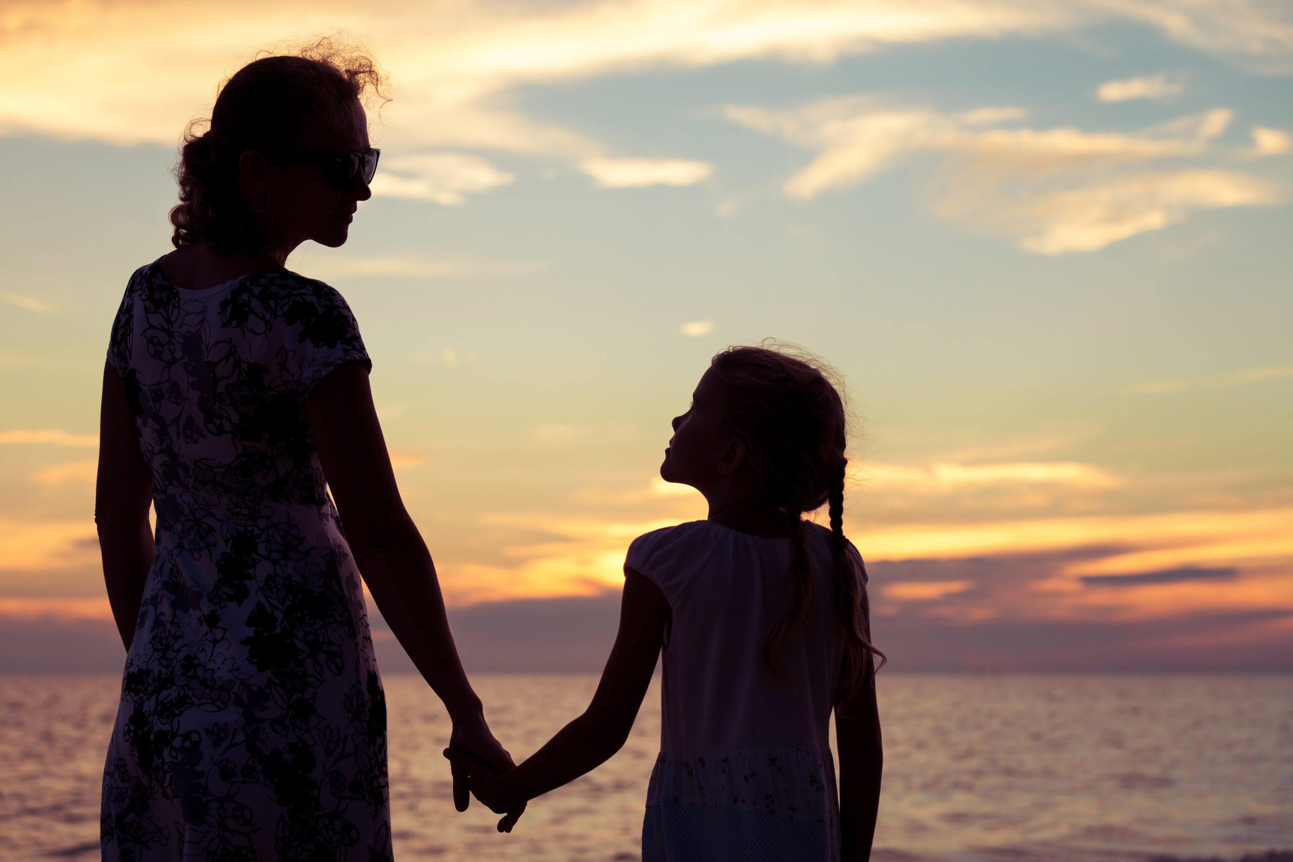 mother daughter at sunset on the beach
