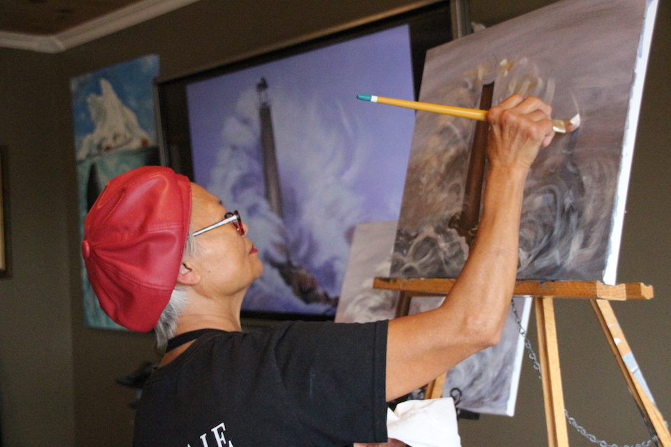 Artist Brenda Matchim works on a painting