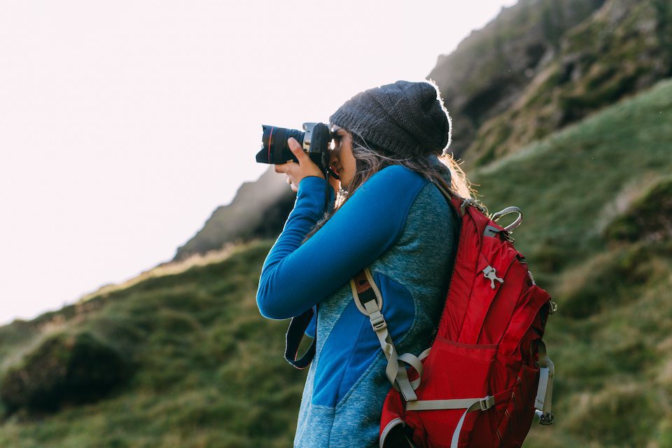 A woman photographs Iceland during her travels