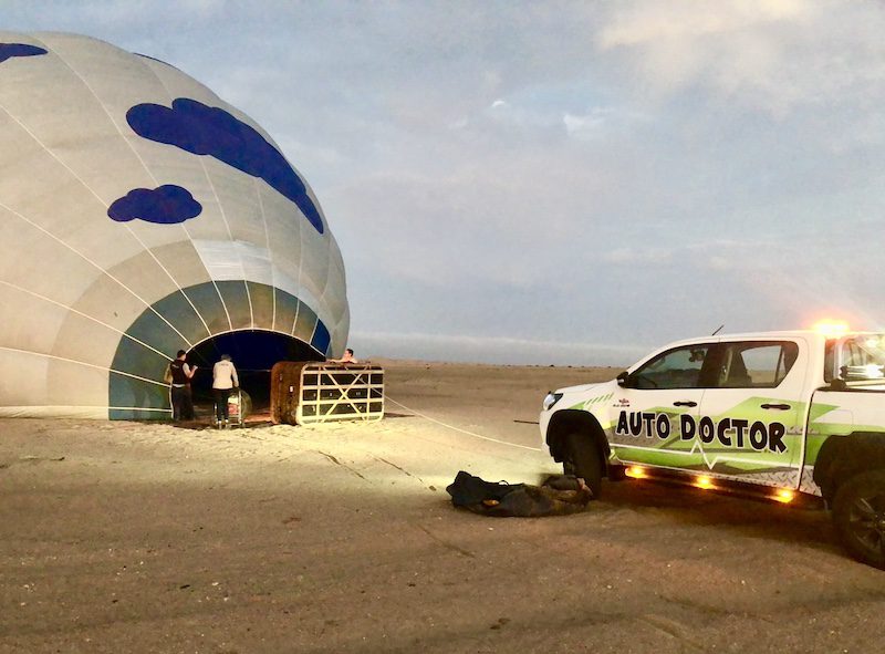 A balloon getting filled with air to prepare for take off on a hot air balloon safari in Namibia