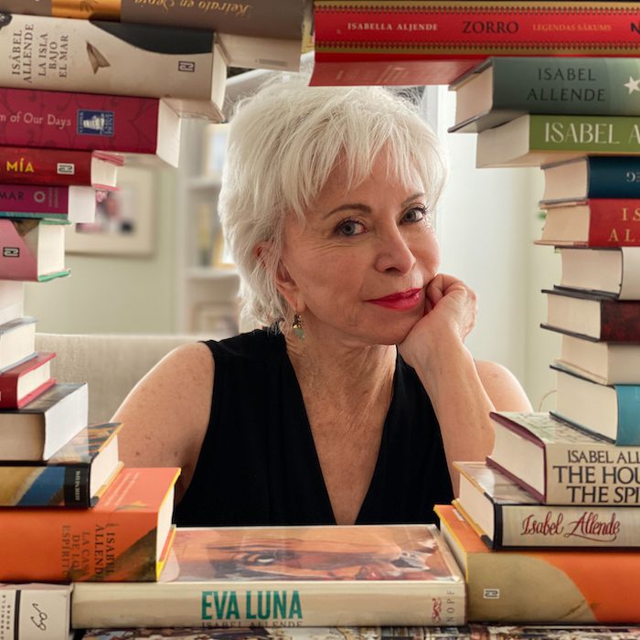 Author Isabel Allende surrounded by books