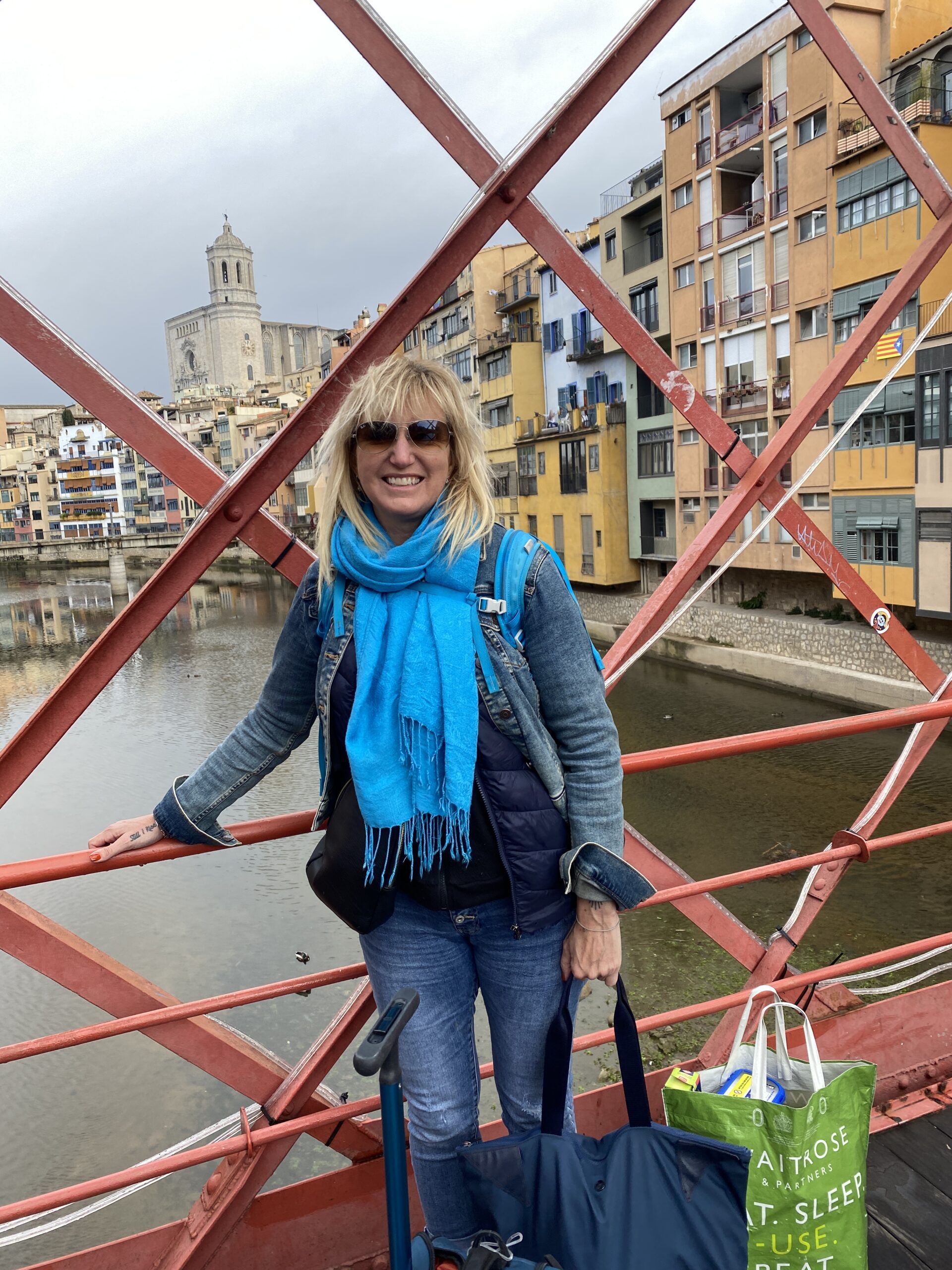Carolyn Ray stands with her arms up in Seville, Spain