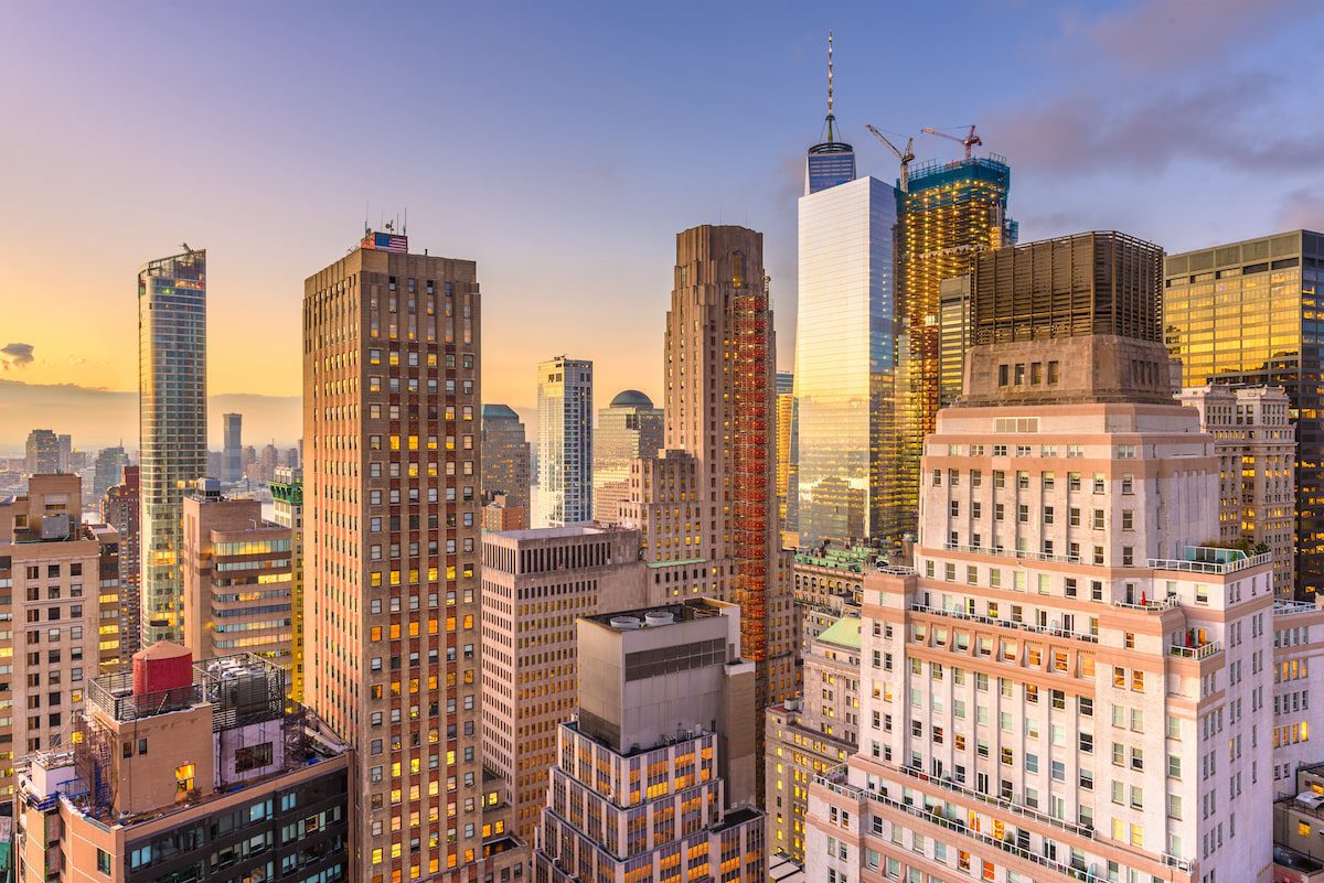 New York City skyline at sunset, as the sun reflects on the buildings