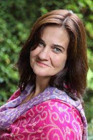 Author Isabel Allende surrounded by books