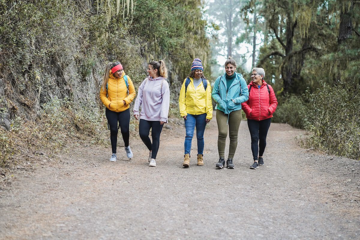 Women having fun during a hike through a park