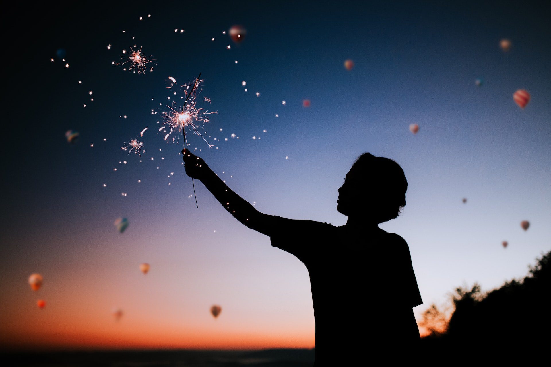 Women in silhouette holding sparkler