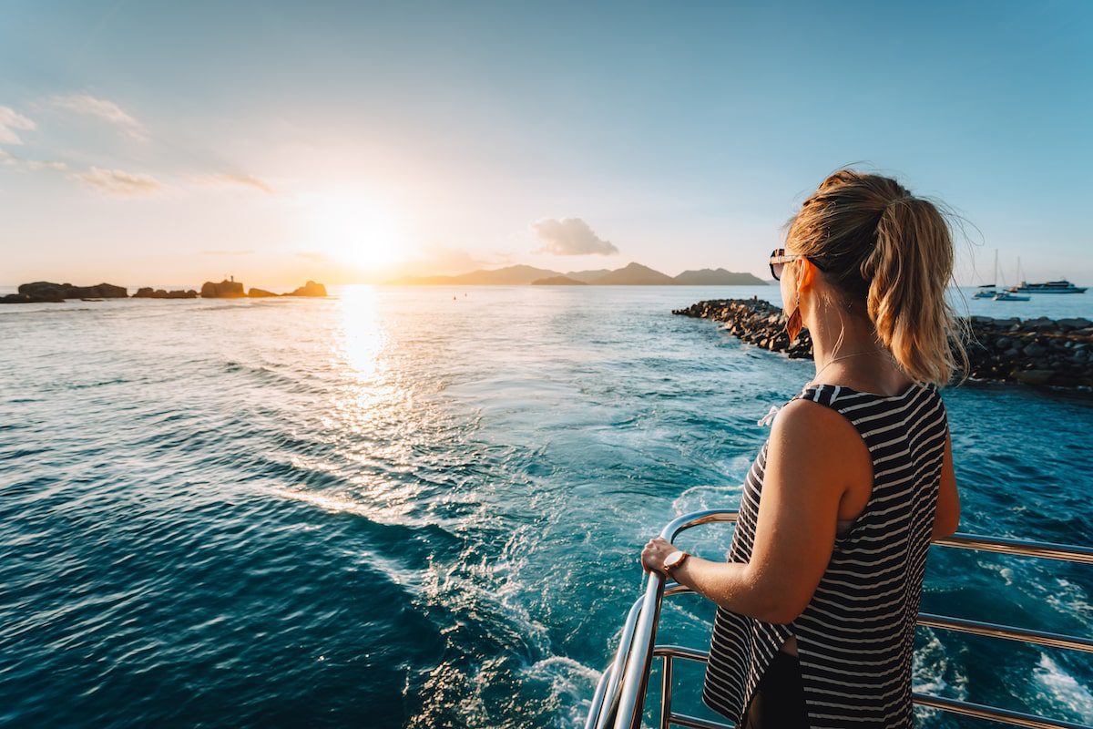 Woman on a boat overlooking the sea dealing with motion sickness