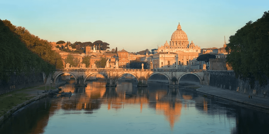 photo of lake and old italian building at sunset time