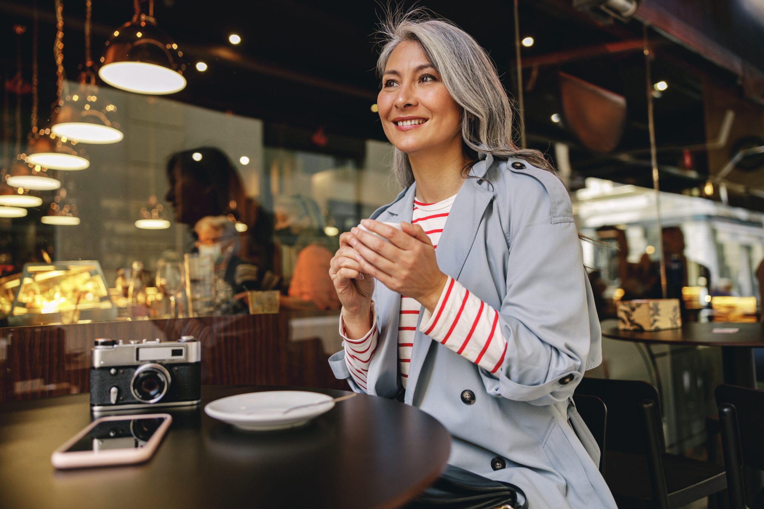 senior woman eating alone in a market