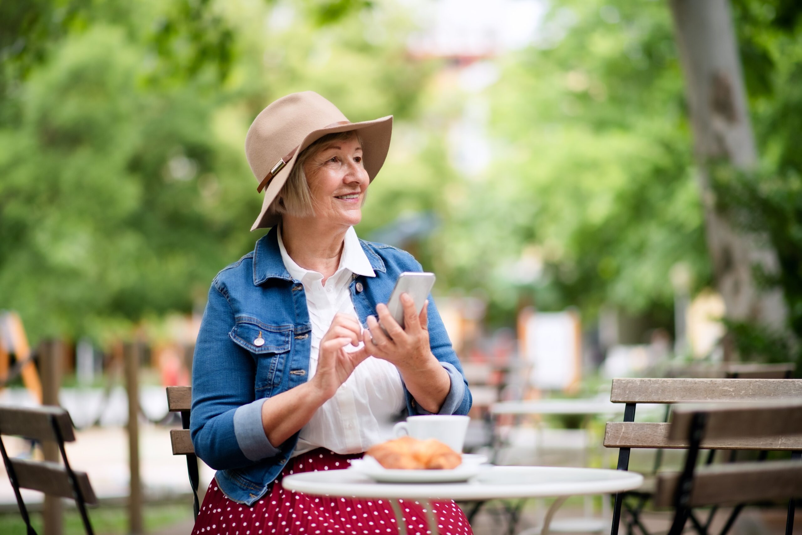 senior woman eating alone in cafe