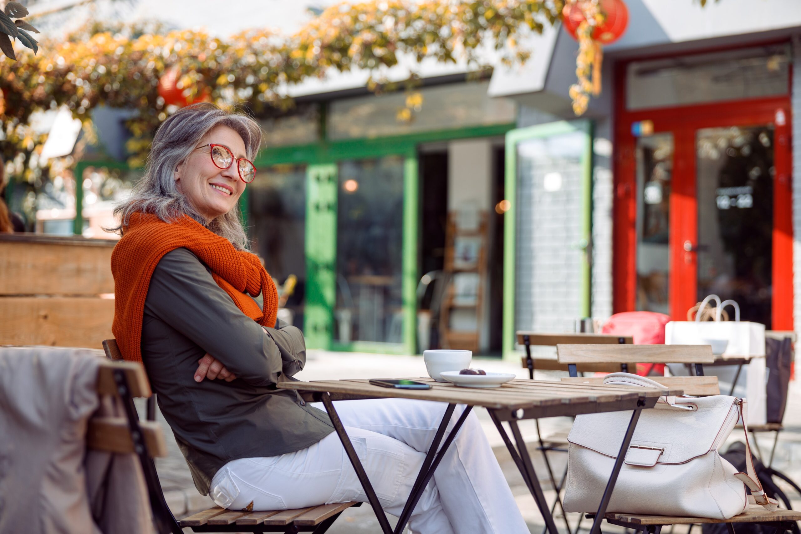 smiling woman eating alone at a cafe