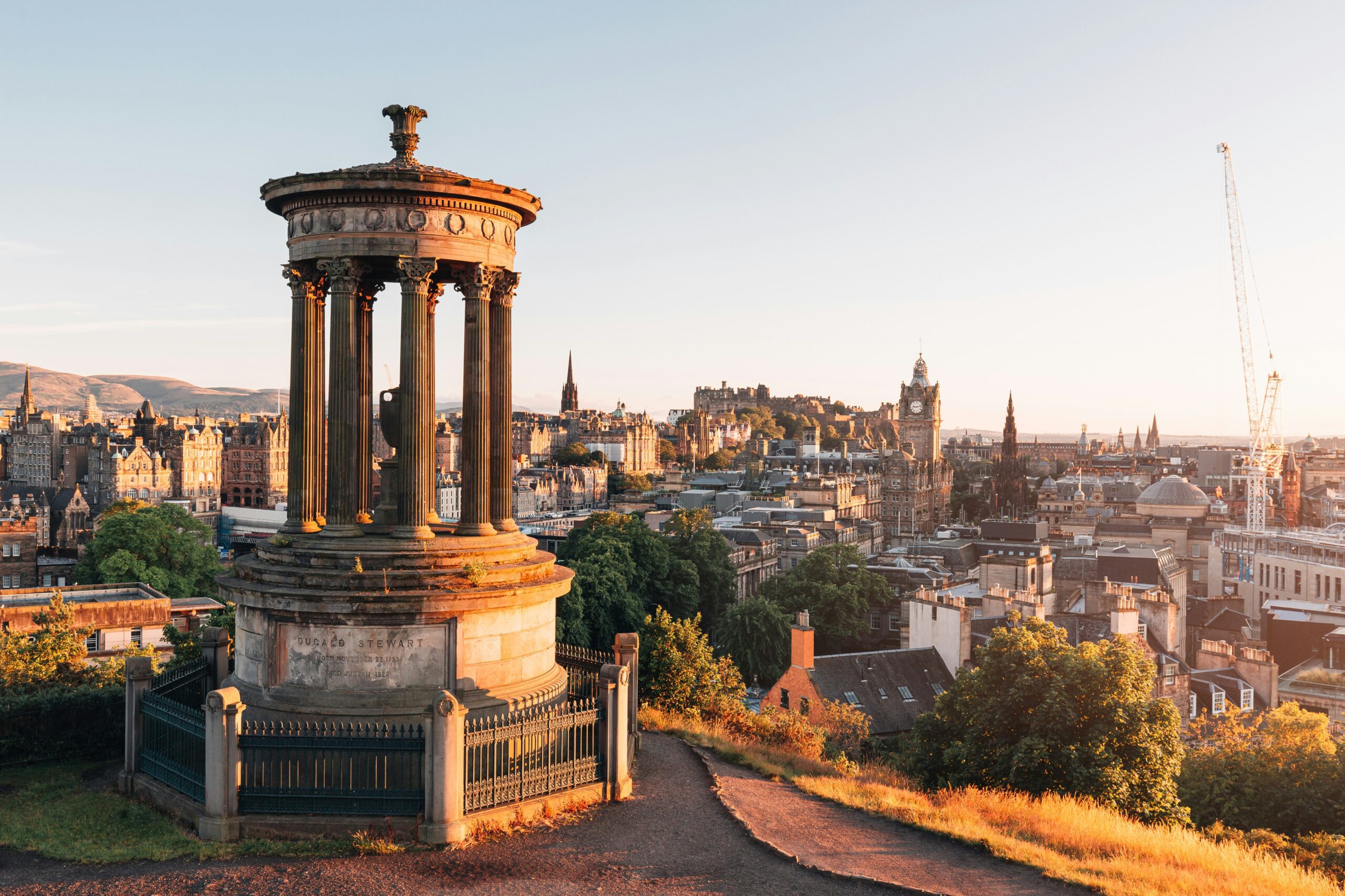 Overlooking Edinburgh city with old stone statues and buildings