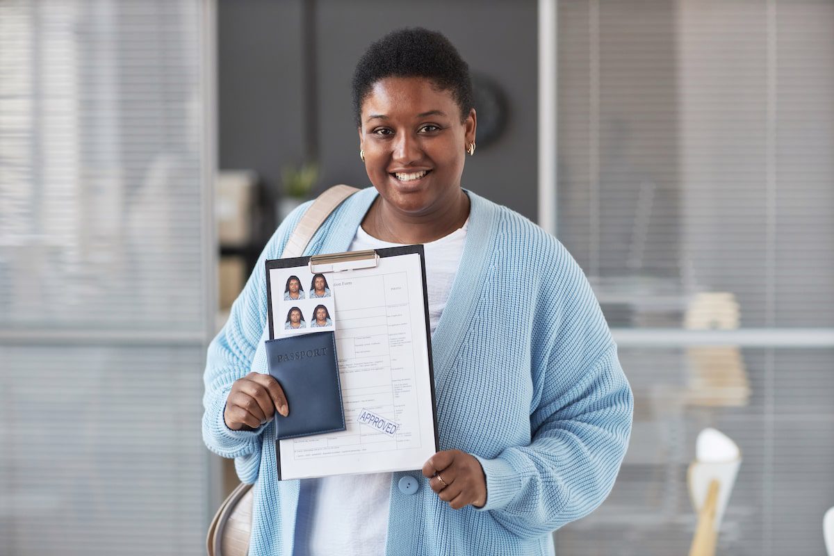 A woman holds up her application for European visas for travel