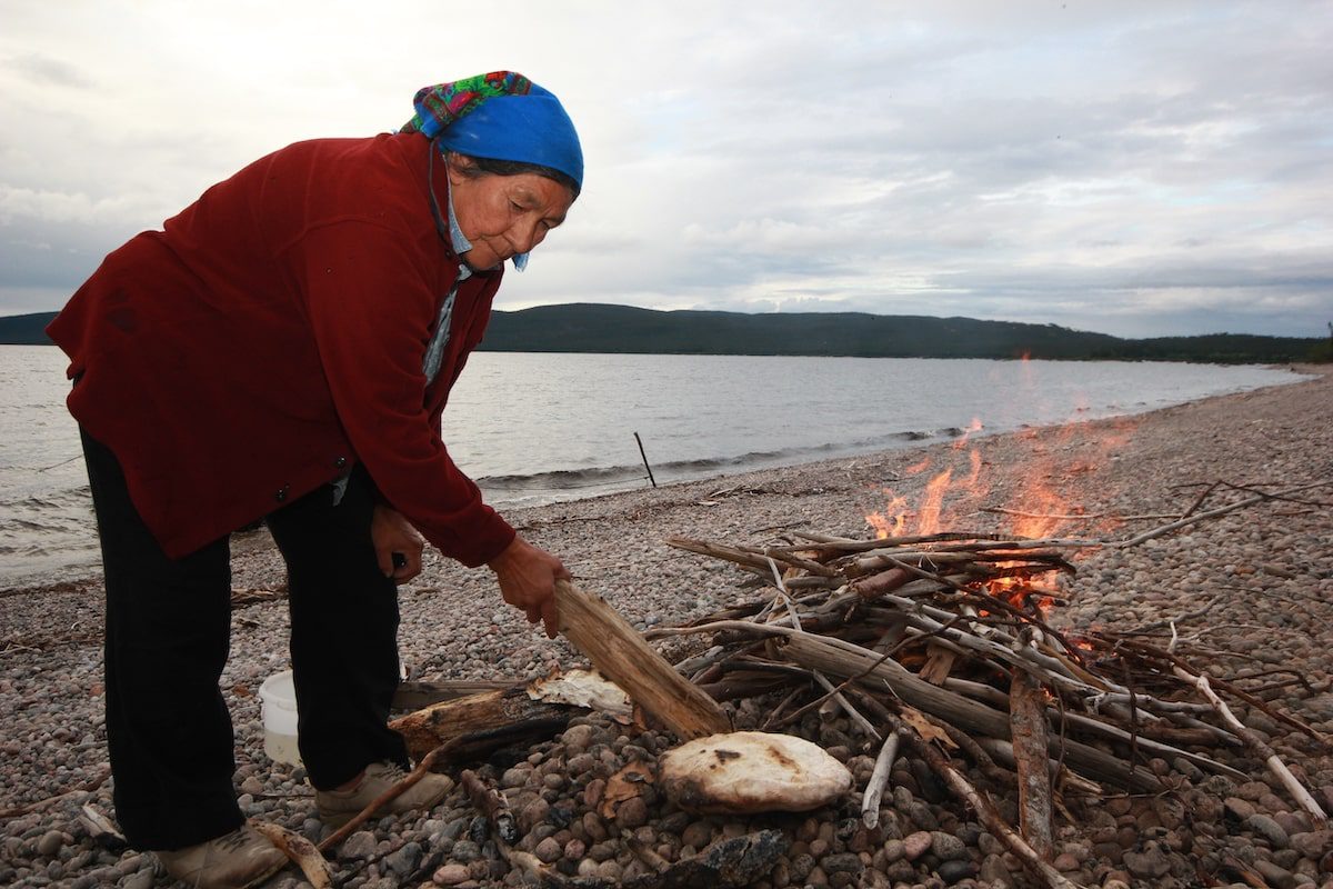 Mrs P had carefully pushed the burning branches aside then removed the sand bread from its beach oven. Done to perfection!