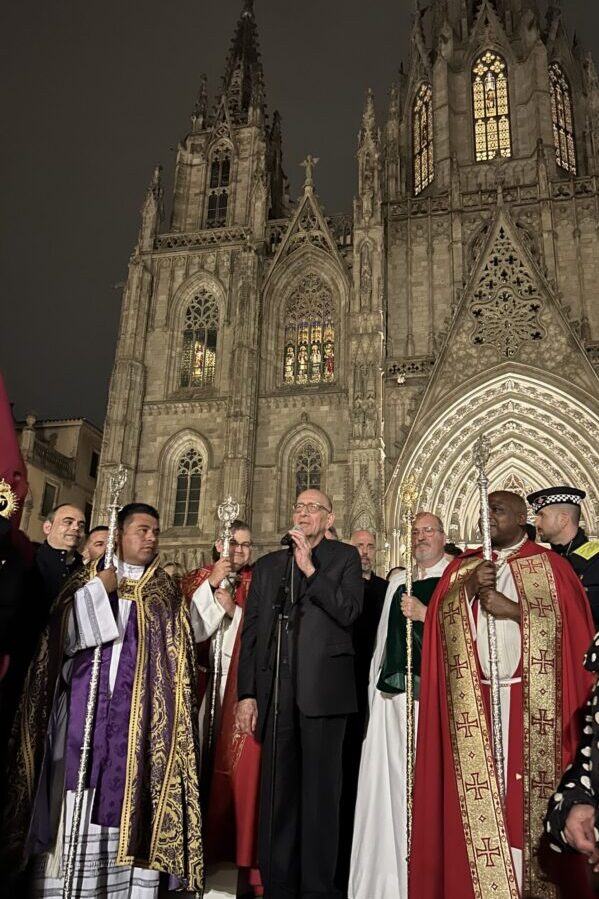 Men standing on the steps of the Barcelona Cathedral during Holy Week Easter