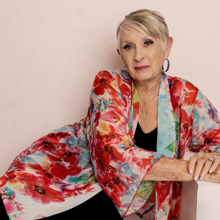 Joy fox wearing a floral sweater