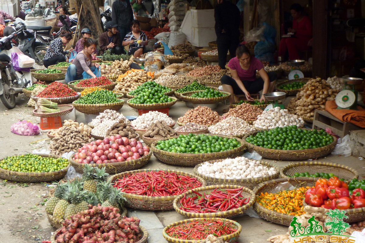 Various baskets filled with different foods and produce at a market in Vietnam