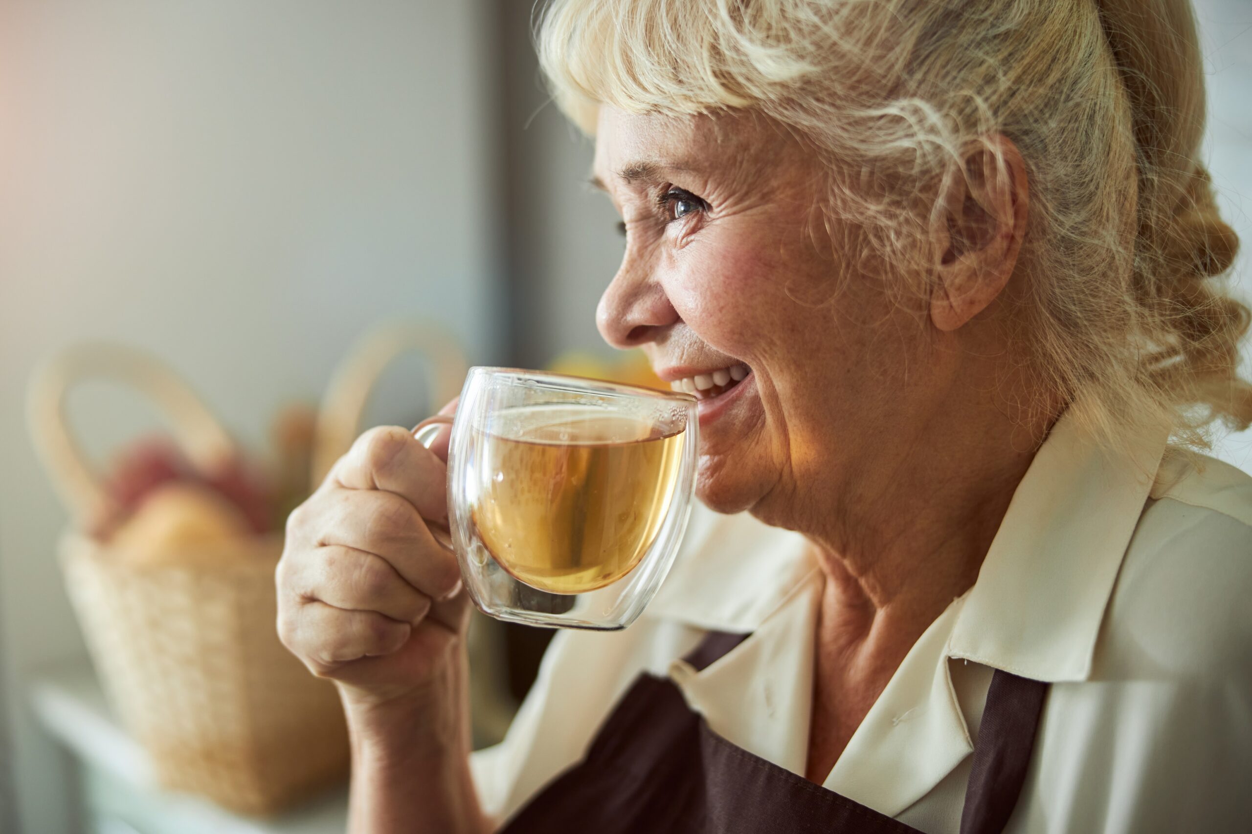 smiling woman drinking tea how to deal with loneliness solo travel 